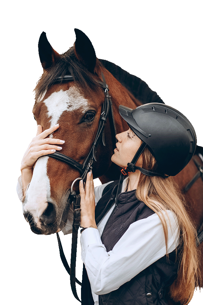 A young woman in a riding helmet gently holds the face of a chestnut horse with white markings, showing a close bond.